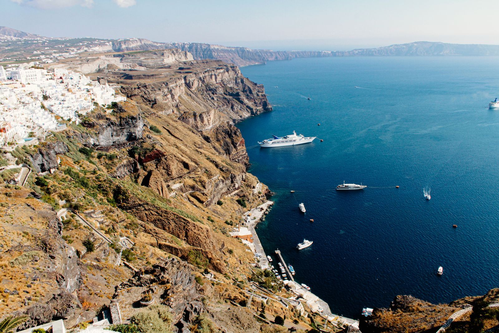 Cruise ships anchored below the cliffs of Santorini, Greece, one of the best cruise destinations in the Mediterranean