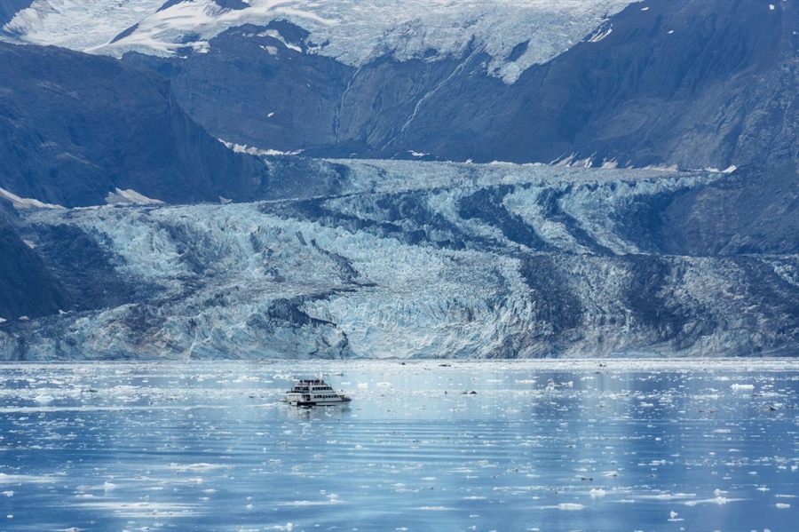 Small boat in front of a tidewater glacier in Alaska