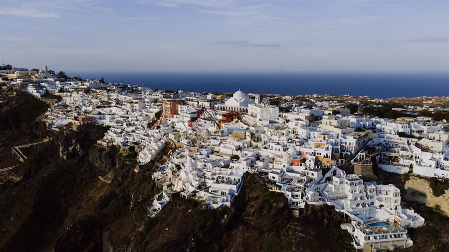 Aerial view of the white buildings of Fira on the Santorini cliffs